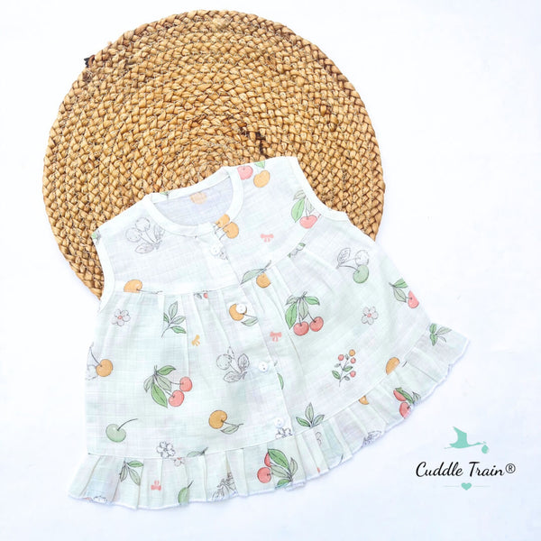 White dress with fruit pattern on a white background, featuring the brand 'Cuddle Train'.