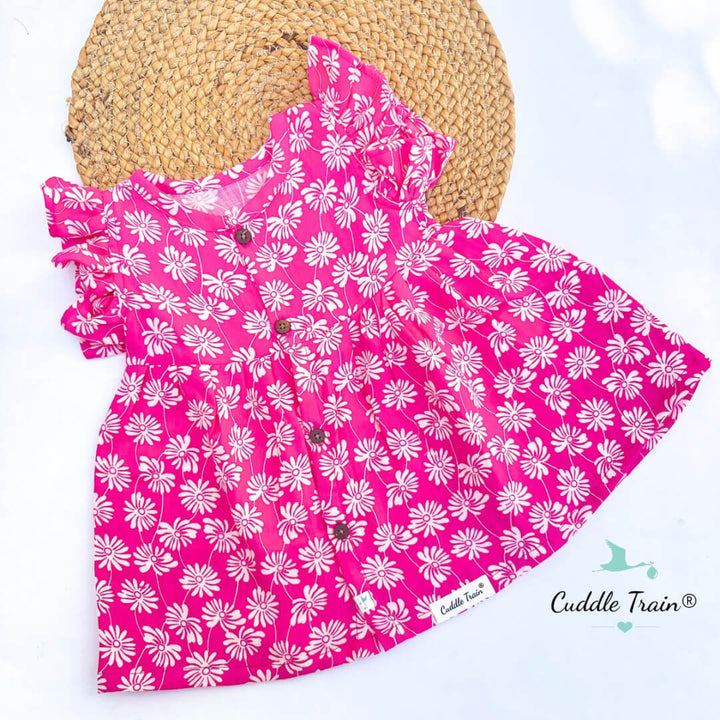 Pink dress with white floral pattern on a white background