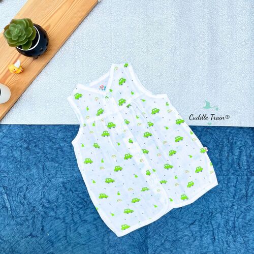 Baby frock with green car pattern on a textured surface, brand 'Cuddle Train' visible