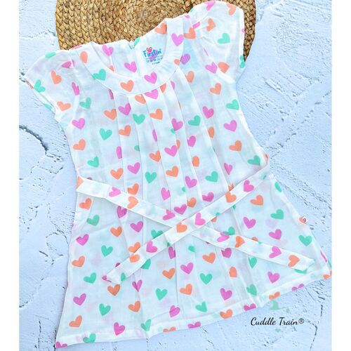 Baby frock with colorful heart pattern on a textured blue surface