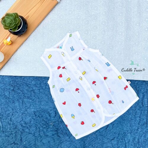 White baby romper with colorful patterns on a blue textured surface, brand 'Cuddle Train' visible.