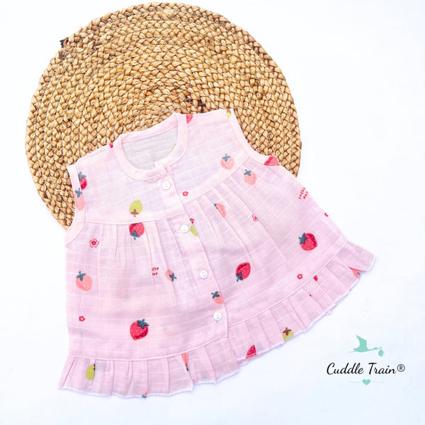 Pink baby dress with strawberry pattern on a white background