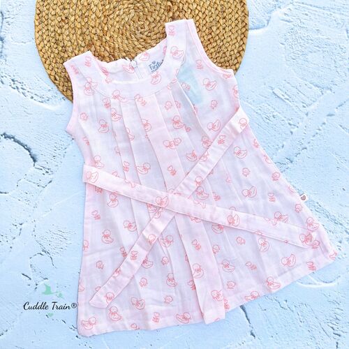 White dress with pink patterns on a textured blue surface