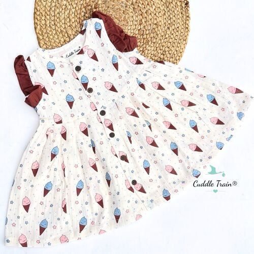 Children's dress with ice cream cone pattern and straw hat on a white background