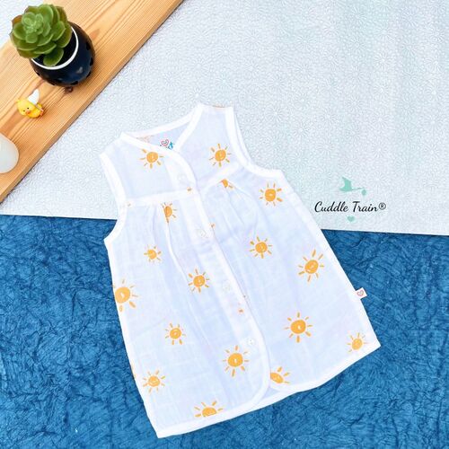 White sleeveless top with yellow sun patterns on a textured surface, with 'Cuddle Train' branding.