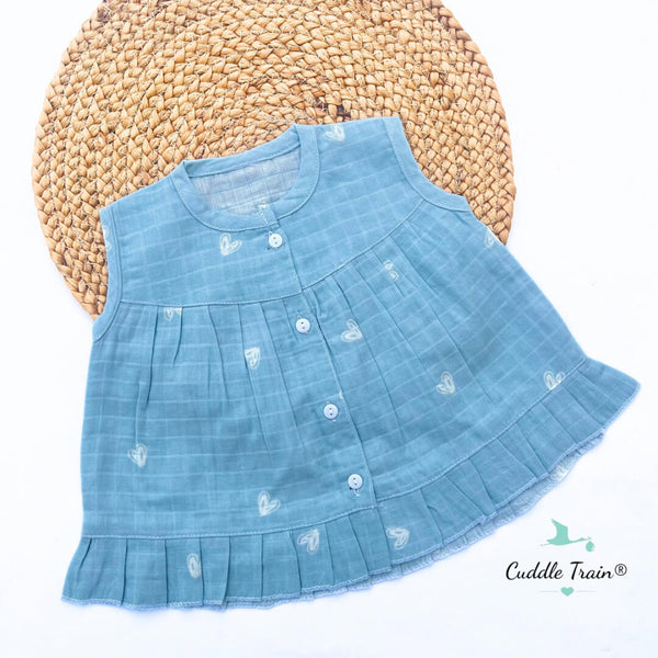 Blue denim dress with white patterns on a textured surface